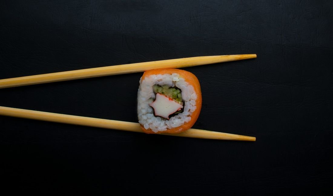 Sushi roll with chopsticks