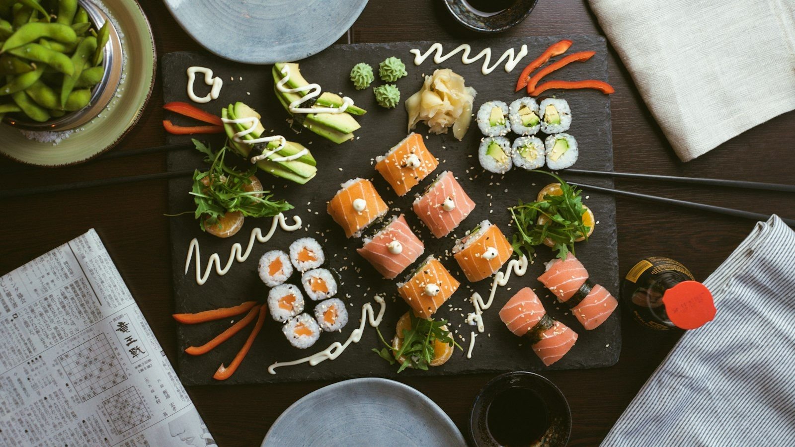 Sushi rolls and nigiri on a dark table